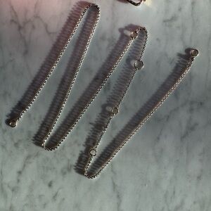 Marla Aaron 36” Rolo Chain Silver w/6 gold rings, 1 larger then the others